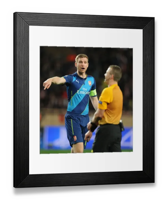 Framed Print : Arsenal's Per Mertesacker Confers with Referee during Monaco Showdown in 2015 Champions League