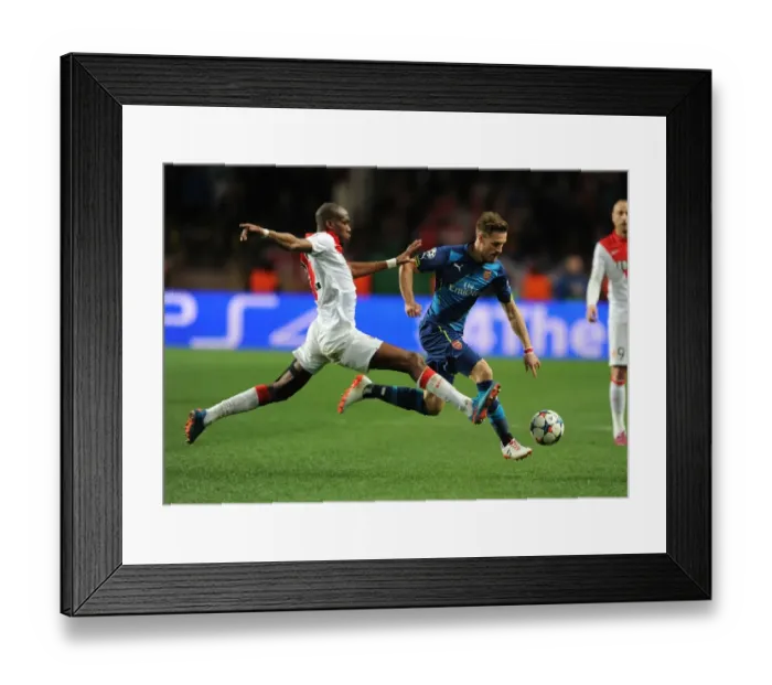 Framed Print : Arsenal's Aaron Ramsey Outmaneuvers Monaco's Geoffrey Kondogbia in UEFA Champions League Clash