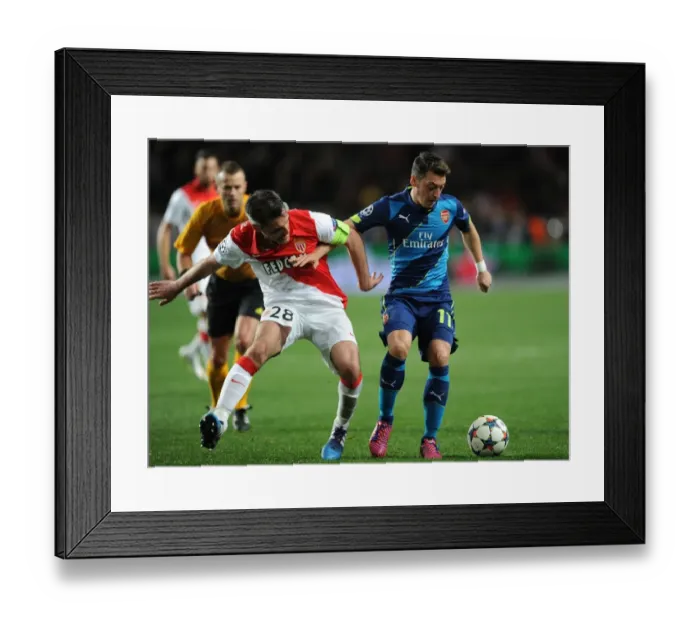 Framed Print : Mesut Ozil vs. Jeremy Toulalan: Intense Battle in Monaco's UCL Clash Against Arsenal