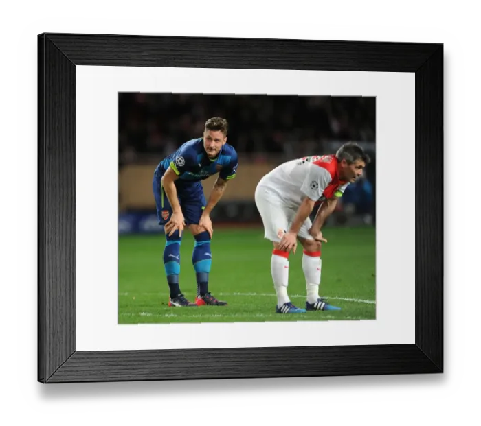 Framed Print : Breathless Moment: Olivier Giroud and Jeremy Toulalan Lock Eyes During Intense Monaco vs. Arsenal UCL Clash
