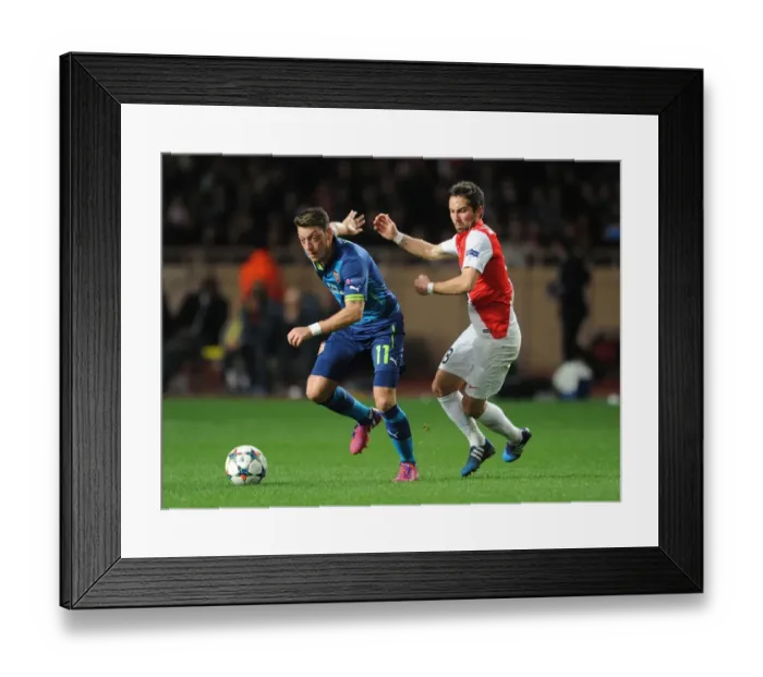 Framed Print : Mesut Ozil vs Joao Moutinho: Battle in the UEFA Champions League Round of 16 between Monaco and Arsenal Framed Print : Mesut Ozil vs Joao Moutinho: Battle in the UEFA Champions League Round of 16 between Monaco and Arsenal