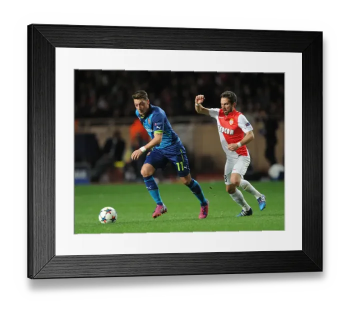 Framed Print : Mesut Ozil vs Joao Moutinho: A Battle of Midfield Maestros in Monaco v Arsenal, UEFA Champions League