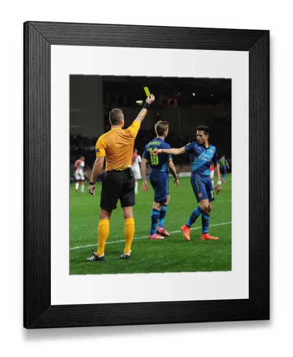 Framed Print : Arsenal's Alexis Sanchez Argues with Referee Svein Oddvar Moen during Monaco Clash in UEFA Champions League