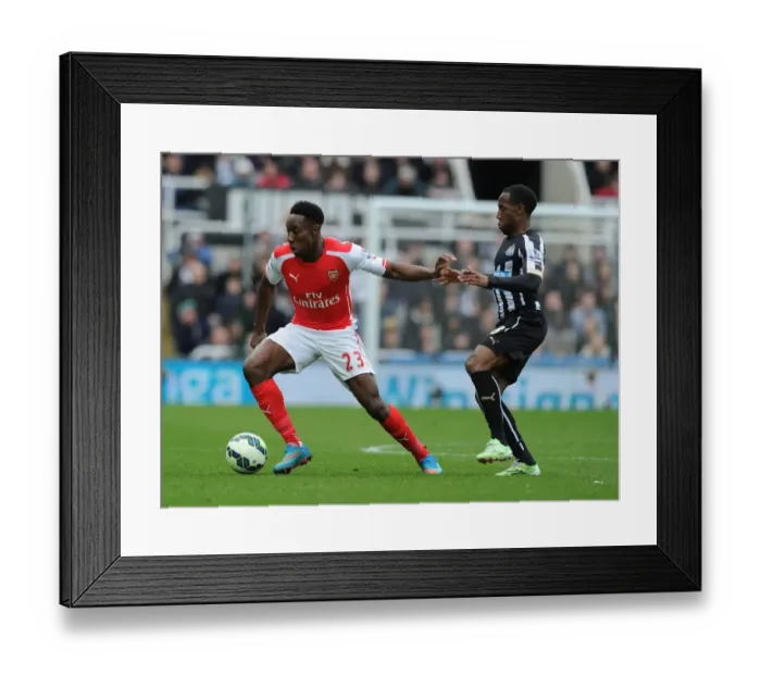 Framed Print : Danny Welbeck vs. Vurnon Anita: Intense Battle at St. James Park - Arsenal vs. Newcastle, Premier League 2014 / 15