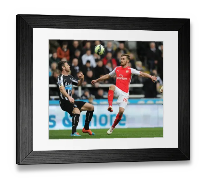 Framed Print : Arsenal vs. Newcastle United: Aaron Ramsey Faces Off Against Mike Williamson in Premier League Clash Framed Print : Arsenal vs. Newcastle United: Aaron Ramsey Faces Off Against Mike Williamson in Premier League Clash