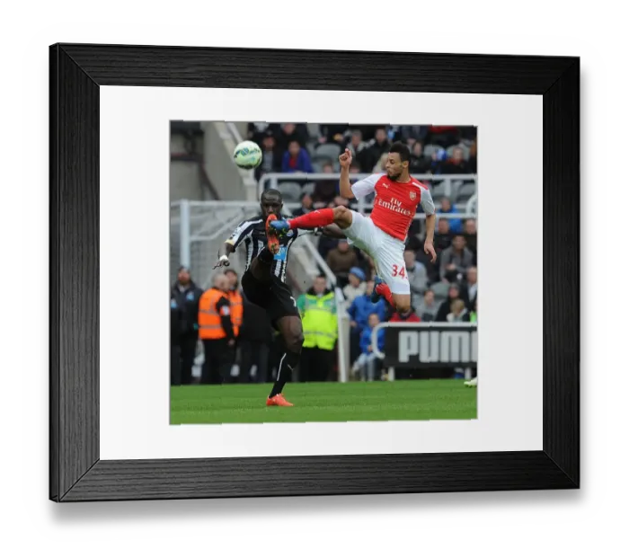 Framed Print : Coquelin vs Sissoko: Intense Battle in Newcastle United vs Arsenal Premier League Clash