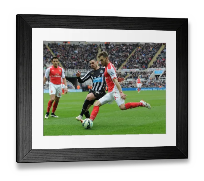 Framed Print : Ramsey vs Cabella: Intense Battle in Newcastle United vs Arsenal Premier League Clash