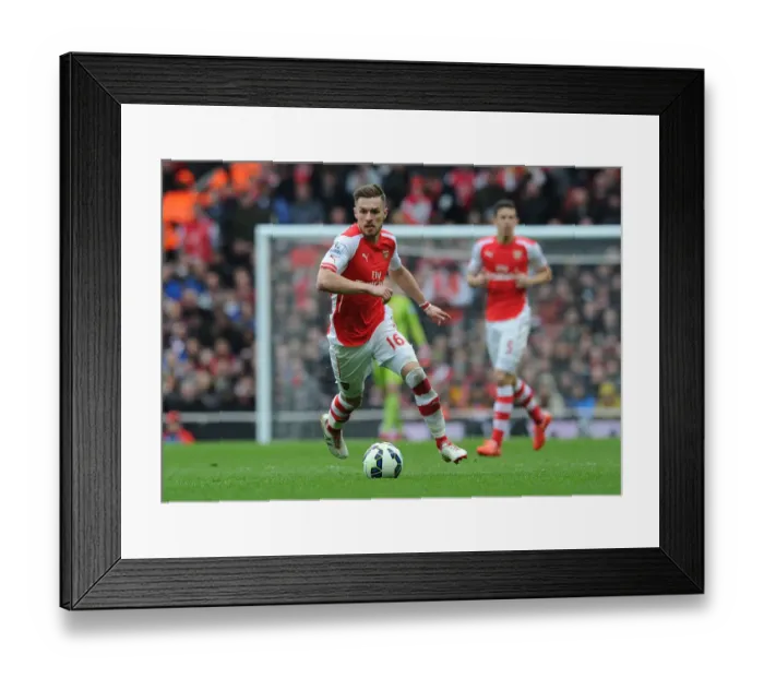 Framed Print : Arsenal vs. Liverpool: Aaron Ramsey's Intense Action in the 2014-15 Premier League Clash at Emirates Stadium Framed Print : Arsenal vs. Liverpool: Aaron Ramsey's Intense Action in the 2014-15 Premier League Clash at Emirates Stadium