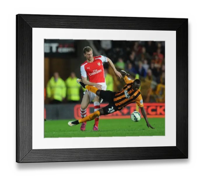 Framed Print : Per Mertesacker vs. Dame N'Doye: Intense Tackle in Arsenal's Victory over Hull City Framed Print : Per Mertesacker vs. Dame N'Doye: Intense Tackle in Arsenal's Victory over Hull City