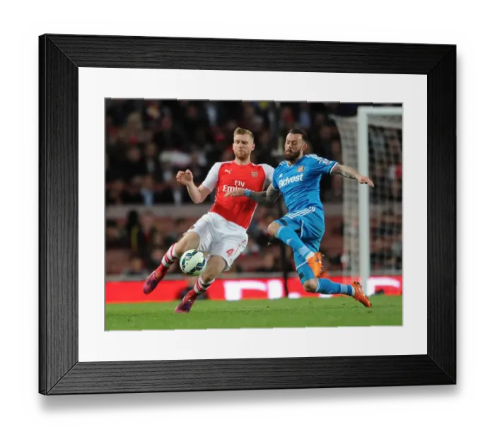 Framed Print : Per Mertesacker vs. Steven Fletcher: Intense Clash in Arsenal vs. Sunderland Premier League Match
