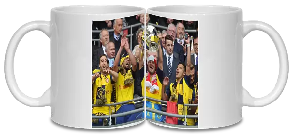 Mathieu Flamini, Francis Coquelin, Santi Cazorla and Alexis Sanchez lift the FA Cup after the match