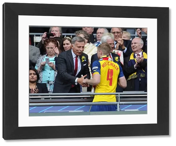 Arsenal Director Stan Kroenke shakes hands with Per Mertesacker (Arsenal) after the match