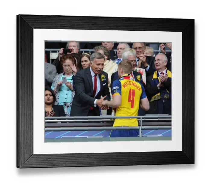 Framed Print : Arsenal Director Stan Kroenke shakes hands with Per Mertesacker (Arsenal) after the match