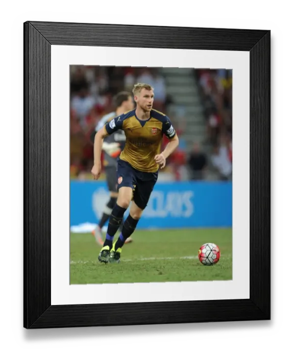 Framed Print : Per Mertesacker in Action: Arsenal vs. Singapore XI at Singapore National Stadium