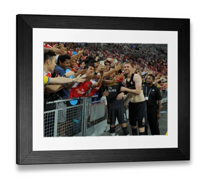Framed Print : Arsenal's Per Mertesacker Celebrates with Fans after Arsenal's Victory over Singapore XI in Singapore, 2015 Framed Print : Arsenal's Per Mertesacker Celebrates with Fans after Arsenal's Victory over Singapore XI in Singapore, 2015
