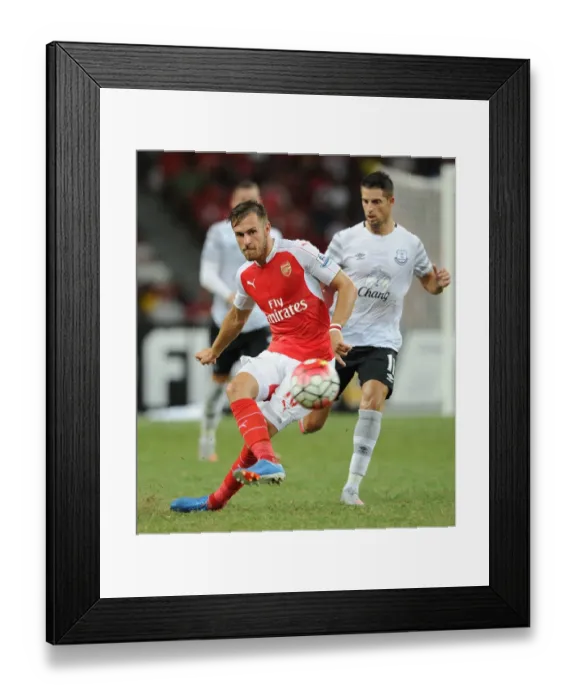 Framed Print : Arsenal's Aaron Ramsey Outsmarts Everton's Kevin Mirallas in Barclays Asia Trophy Clash Framed Print : Arsenal's Aaron Ramsey Outsmarts Everton's Kevin Mirallas in Barclays Asia Trophy Clash