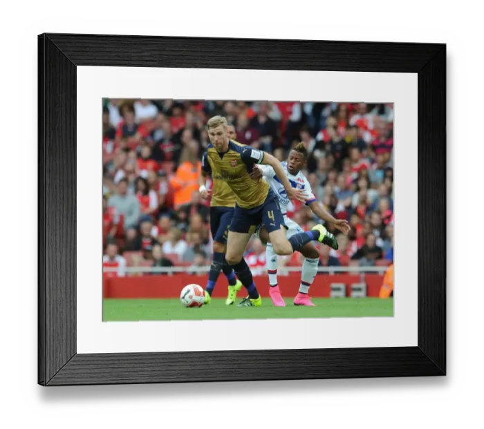 Framed Print : Arsenal's Per Mertesacker vs. Clinton N'Jie: A Tense Face-Off at the Emirates Cup