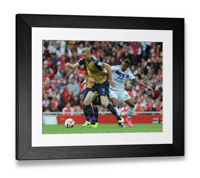 Framed Print : Per Mertesacker vs. Clinton N'Jie: A Battle at the Emirates Cup