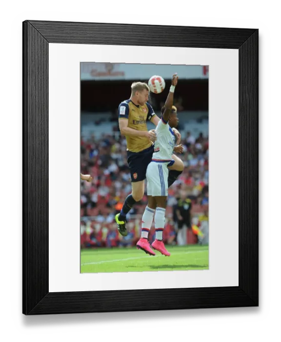 Framed Print : Mertesacker vs. N'Jie: A Tense Face-Off at Arsenal's Emirates Cup Framed Print : Mertesacker vs. N'Jie: A Tense Face-Off at Arsenal's Emirates Cup