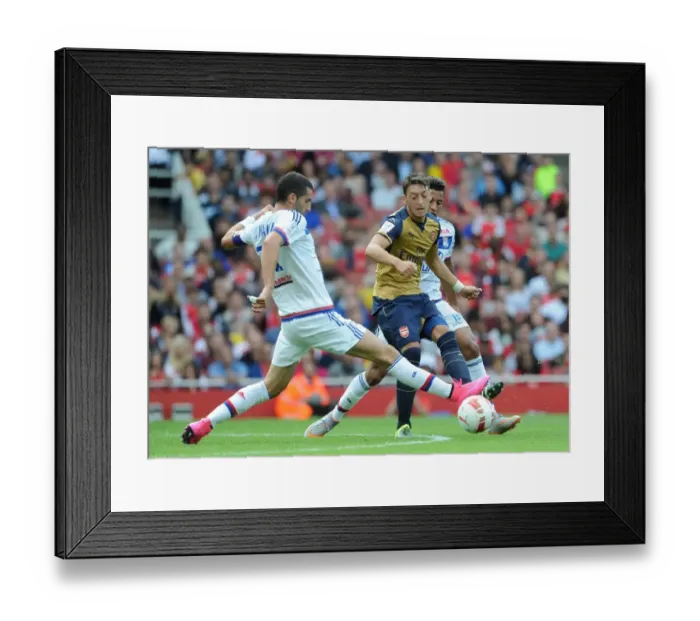 Framed Print : Mesut Ozil vs. Maxime Gonalons: A Tactical Showdown at the Emirates Cup