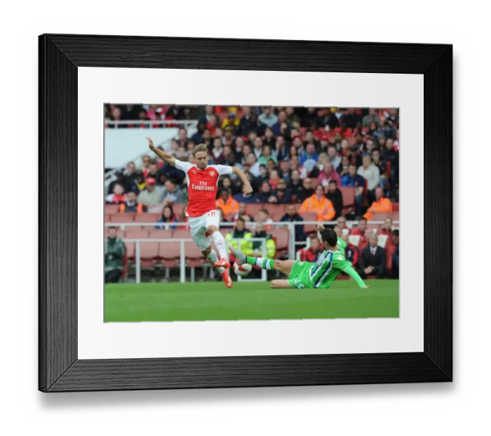 Framed Print : Monreal vs. Trasch: Intense Clash Between Arsenal's Monreal and VfL Wolfsburg's Trasch at Emirates Cup 2015 / 16