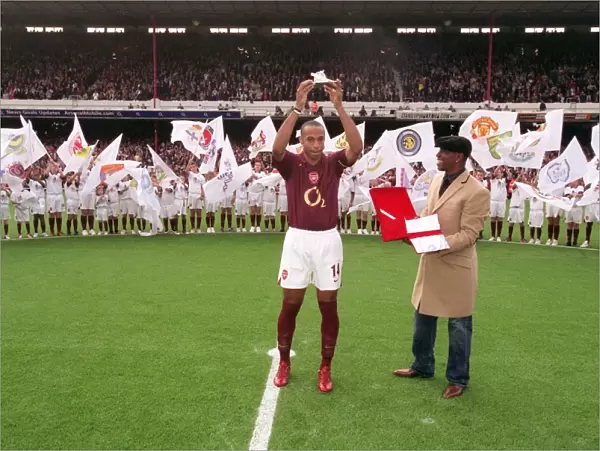 Thierry Henry is presented with a golden canon by Ian Wright for becoming Arsenals all time record