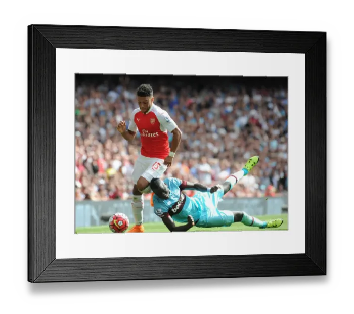Framed Print : Arsenal's Oxlade-Chamberlain vs. West Ham's Kouyate: Intense Clash in Premier League Showdown Framed Print : Arsenal's Oxlade-Chamberlain vs. West Ham's Kouyate: Intense Clash in Premier League Showdown