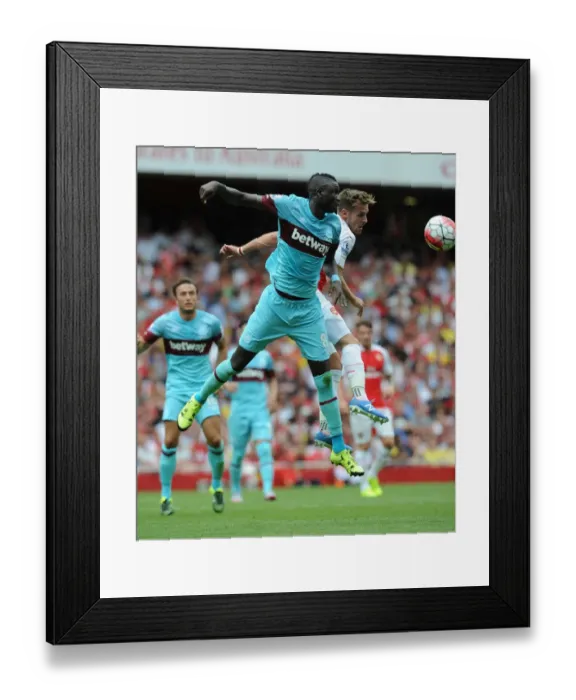 Framed Print : Ramsey vs. Kouyate: A Battle of Midfielders in Arsenal vs. West Ham Premier League Clash