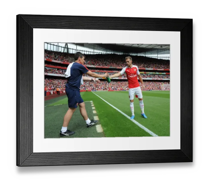 Framed Print : Arsenal's Aaron Ramsey Rehydrates During Arsenal vs West Ham United Match