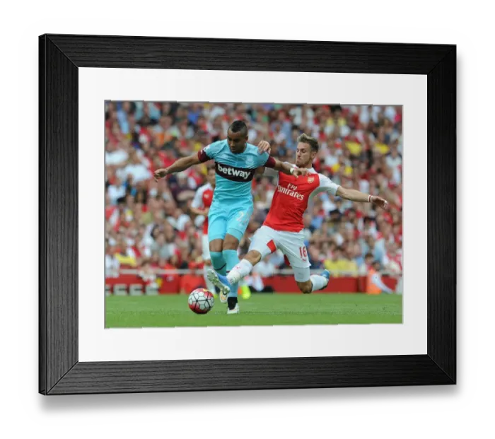 Framed Print : Intense Tackle: Ramsey vs Payet in Arsenal vs West Ham Premier League Clash