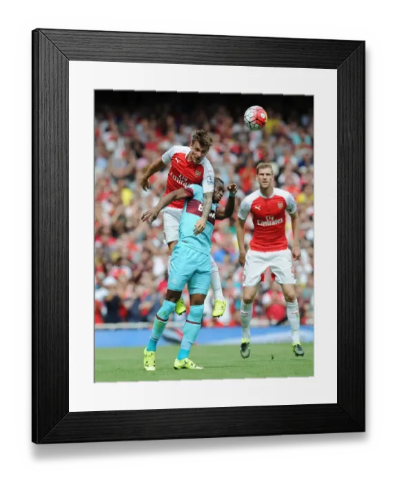 Framed Print : Debuchy Soars Over Sakho: Arsenal vs. West Ham Clash, 2015-16