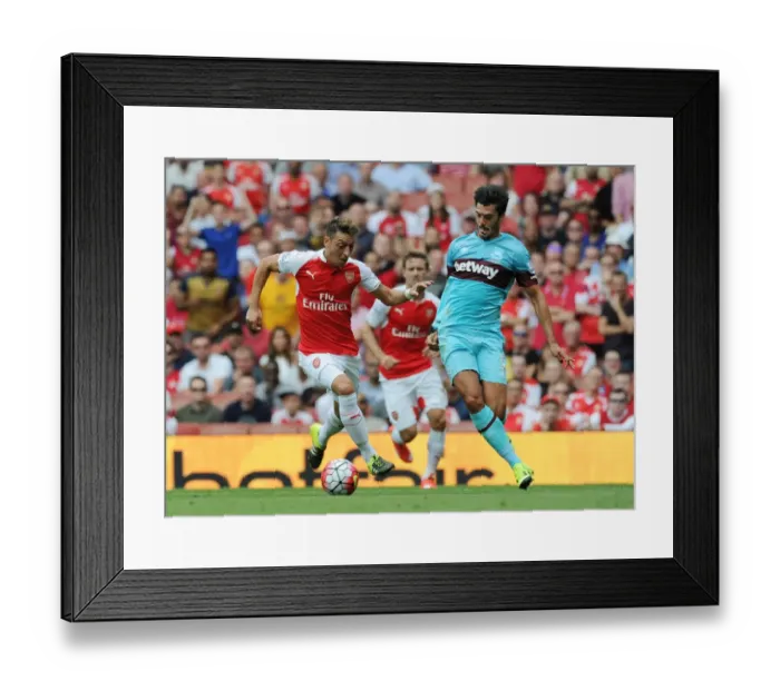 Framed Print : Mesut Ozil Breaks Past West Ham's James Tomkins at Arsenal's Emirates Stadium (Arsenal vs West Ham United, 2015-16)