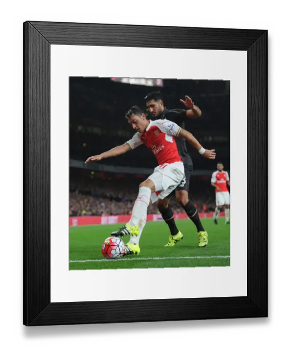 Framed Print : Mesut Ozil vs. Emre Can: A Premier League Battle at Arsenal