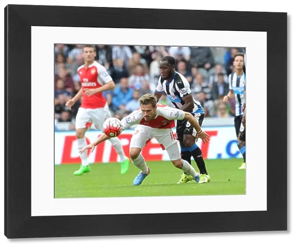 Ramsey Stands Firm: Arsenal Star Holds Off Newcastle's Anita in Intense 2015-16 Premier League Clash