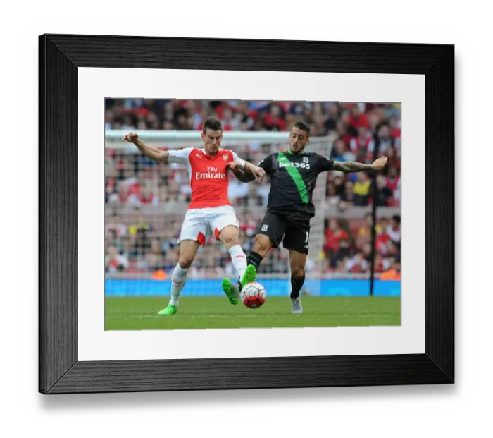 Framed Print : Intense Battle: Koscielny Tackles Joselu in Arsenal vs Stoke City (2015-16)