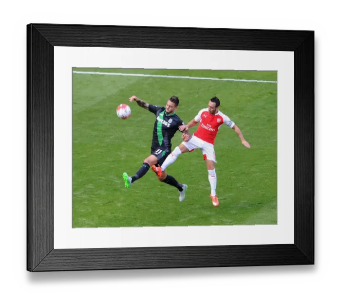 Framed Print : Santi Cazorla vs. Mato Joselu: Intense Battle in Arsenal's Victory over Stoke City Framed Print : Santi Cazorla vs. Mato Joselu: Intense Battle in Arsenal's Victory over Stoke City