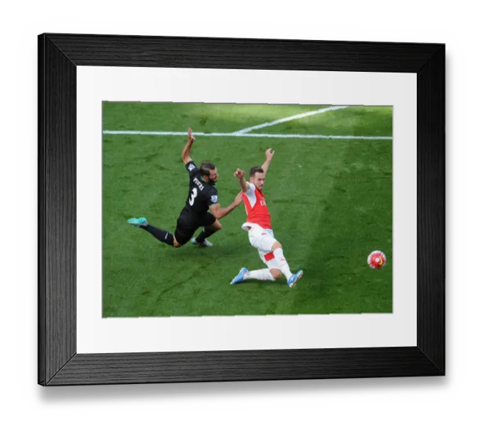 Framed Print : Arsenal's Aaron Ramsey vs. Stoke's Erik Pieters: A Premier League Showdown Framed Print : Arsenal's Aaron Ramsey vs. Stoke's Erik Pieters: A Premier League Showdown