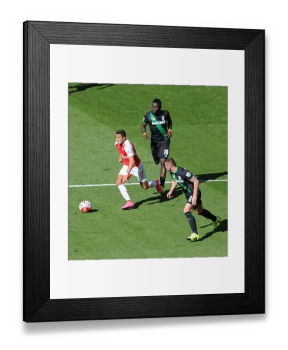 Framed Print : Arsenal's Alexis Sanchez Chases Down Stoke Duo Mame Biram Diouf and Phil Bardsley Framed Print : Arsenal's Alexis Sanchez Chases Down Stoke Duo Mame Biram Diouf and Phil Bardsley
