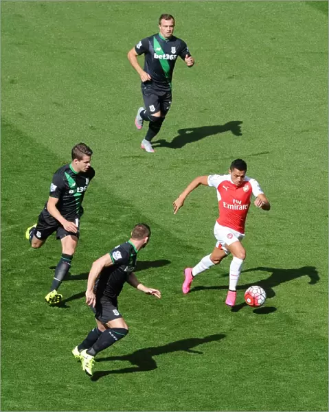 Alexis Sanchez (Arsenal) takes on Xherdan Shaqiri, Marco van Ginkel and Phil Bardsley