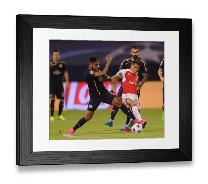 Framed Print : Clash of Stars: Sanchez vs. Soudani - Arsenal's Alexis Sanchez Goes Head-to-Head with Dinamo Zagreb's El Arabi Hilal Soudani