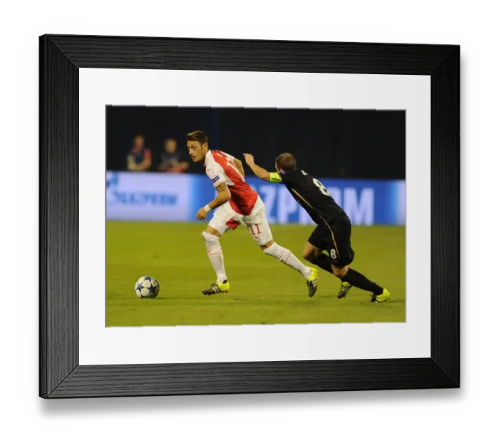 Framed Print : Mesut Ozil vs. Domagoj Antolic: A Battle in Arsenal's Champions League Clash with Dinamo Zagreb (September 2015)