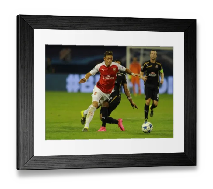 Framed Print : Mesut Ozil Scores Past Dinamo Zagreb's Defense in 2015-16 UEFA Champions League: Arsenal's Star Playmaker in Action