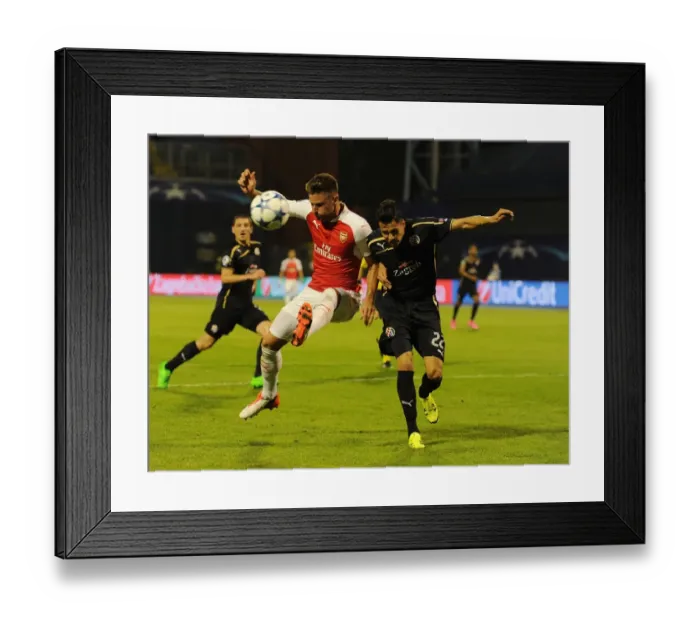 Framed Print : Champions Clash: Olivier Giroud vs. Leonardo Taravel - Arsenal's Star Forward Faces Off Against Dinamo Zagreb's Defender in the 2015-16 UEFA Champions League