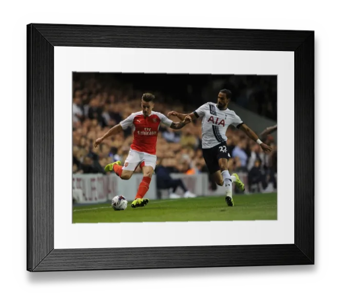 Framed Print : Intense Battle: Debuchy vs Chadli in the Capital One Cup Clash between Tottenham and Arsenal