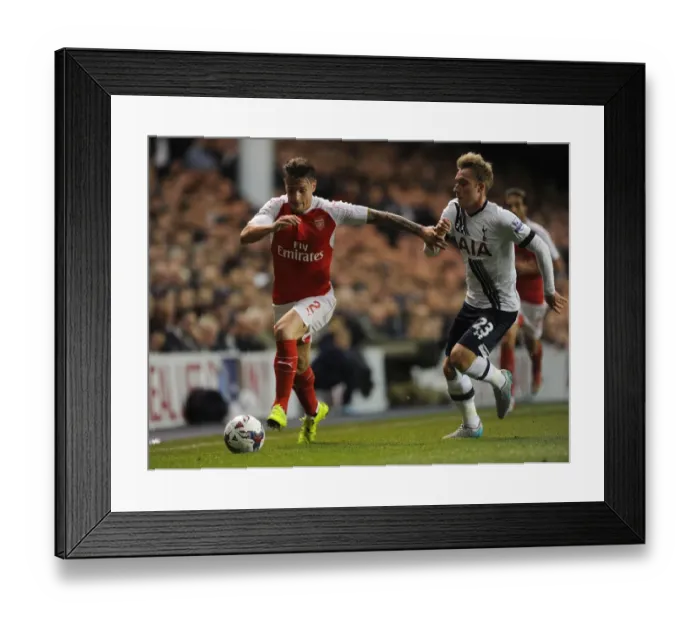 Framed Print : Intense Rivalry: Debuchy vs. Eriksen in the Capital One Cup Showdown between Arsenal and Tottenham