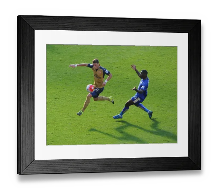 Framed Print : Mesut Ozil vs Jeffrey Schlupp: A Premier League Battle Framed Print : Mesut Ozil vs Jeffrey Schlupp: A Premier League Battle