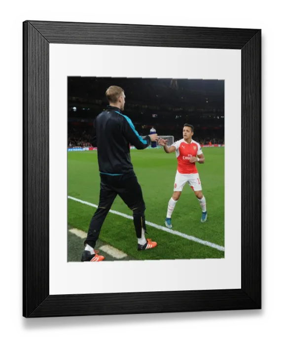 Framed Print : Mertesacker's Support: Alexis Sanchez Receives Water Bottle from TeamMate During Arsenal vs. Olympiacos (2015 / 16) UEFA Champions League Framed Print : Mertesacker's Support: Alexis Sanchez Receives Water Bottle from TeamMate During Arsenal vs. Olympiacos (2015 / 16) UEFA Champions League
