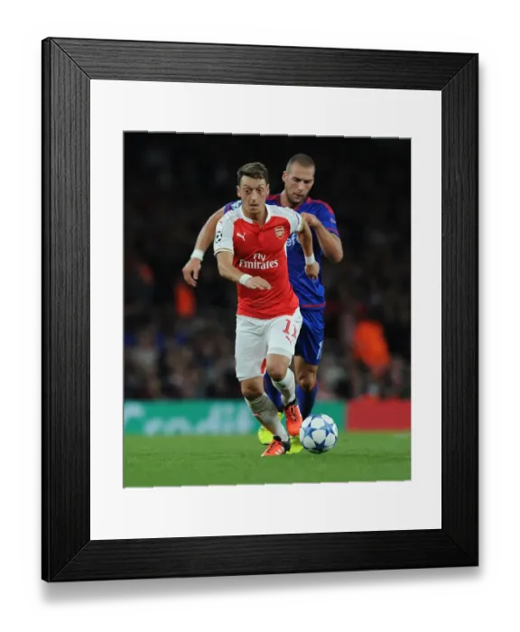 Framed Print : Mesut Ozil vs. Pajtim Kasami: Arsenal vs. Olympiacos Clash in 2015 / 16 UEFA Champions League
