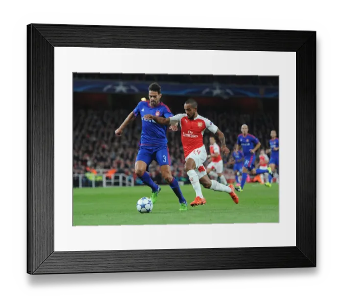 Framed Print : Theo Walcott vs. Alberto Botia: A Fierce Battle in Arsenal's 2015 Champions League Clash