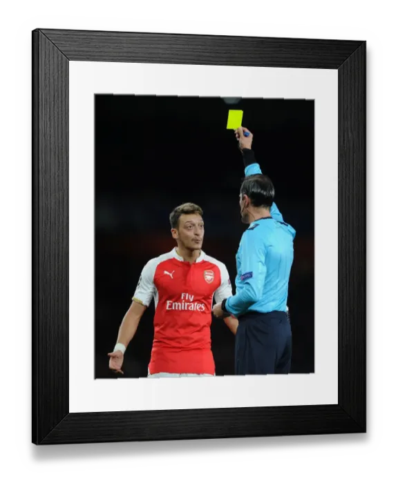 Framed Print : Arsenal's Ozil Receives Yellow Card vs Olympiacos in Champions League (2015 / 16)